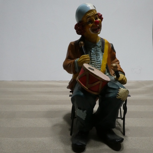 CLOWN porcelain sitting on bench playing the drums